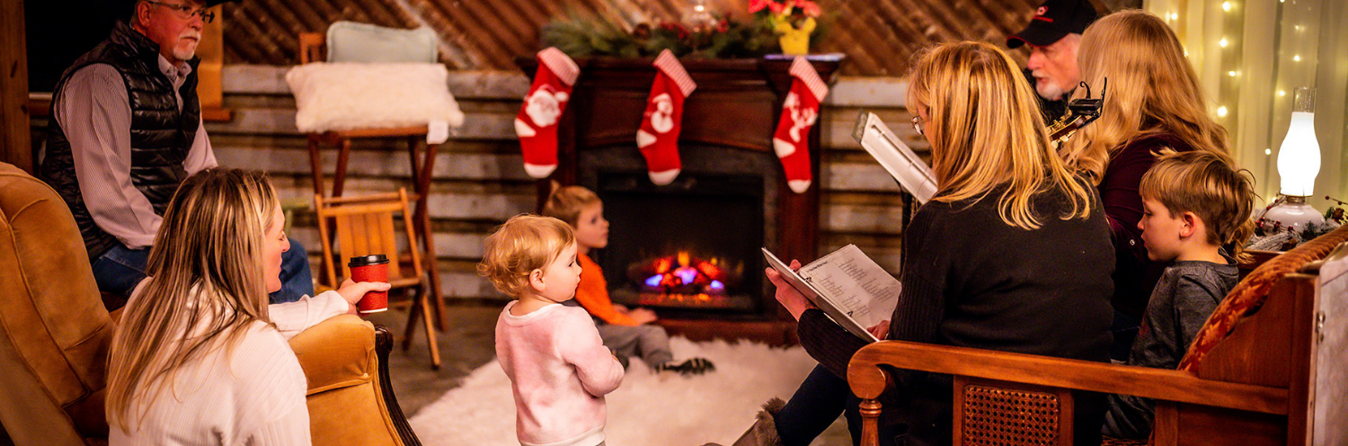 Family sitting and reading before a fireplace